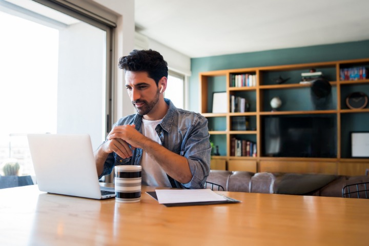 portrait-young-man-working-with-laptop-from-home-while-woman-talking-phone_cleanup